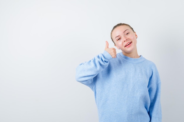 Pleasent girl is showing excellent sign on white background