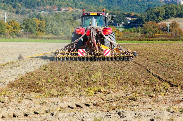 Free Photo ploughing heavy tractor during cultivation agriculture works at field with plough