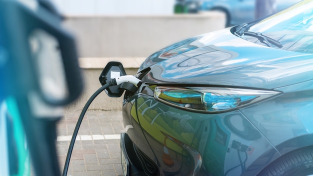 Plugged in charger into an electric car at charge station