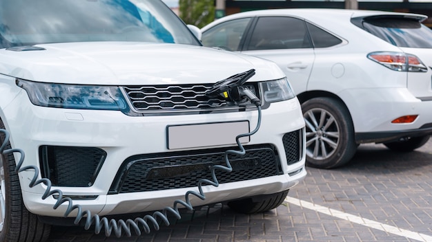 Plugged in charger into an electric car at charge station