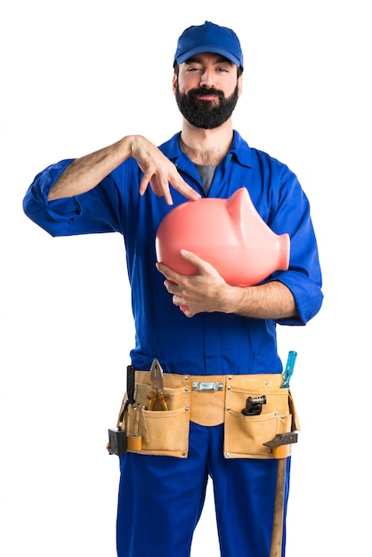 Plumber holding a piggybank