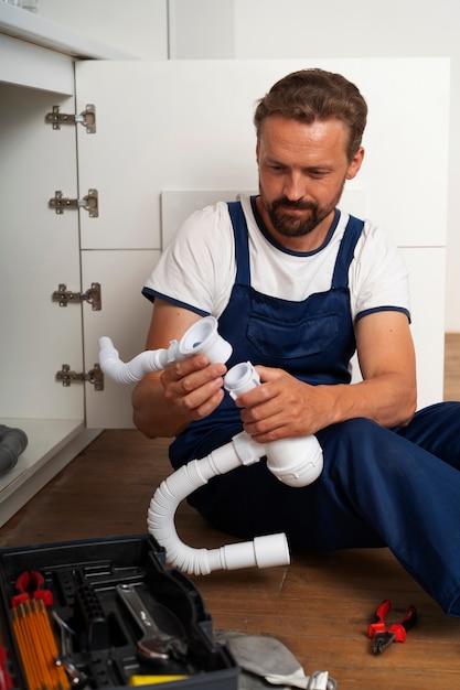 Free Photo plumbing professional doing his job