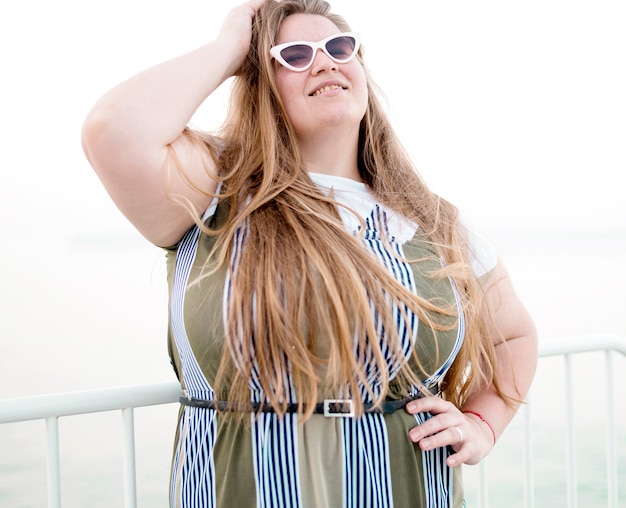 Plus size model wearing sunglasses