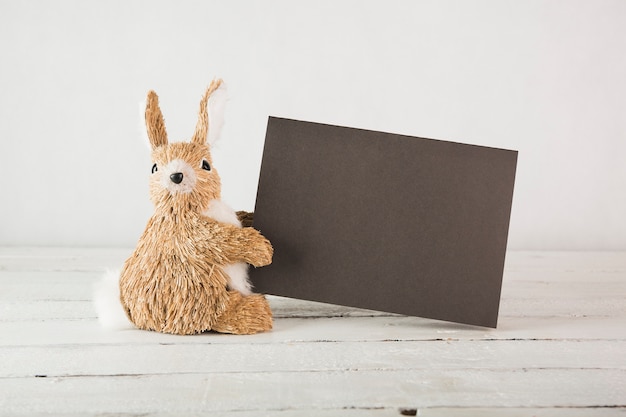 Plush rabbit with black paper