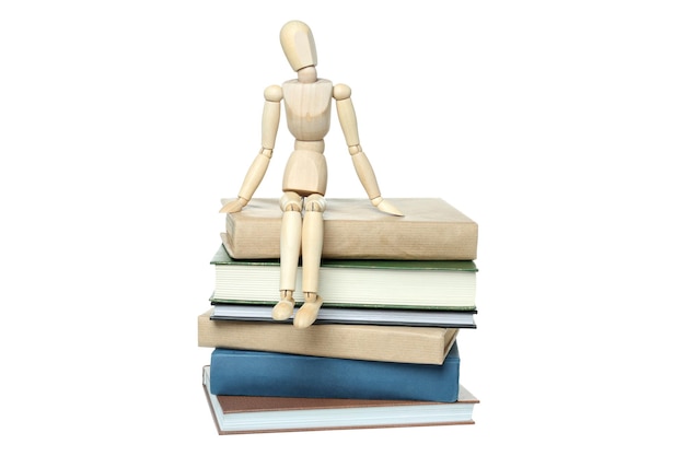 Free photo png a stack of books with a wooden man isolated on white background