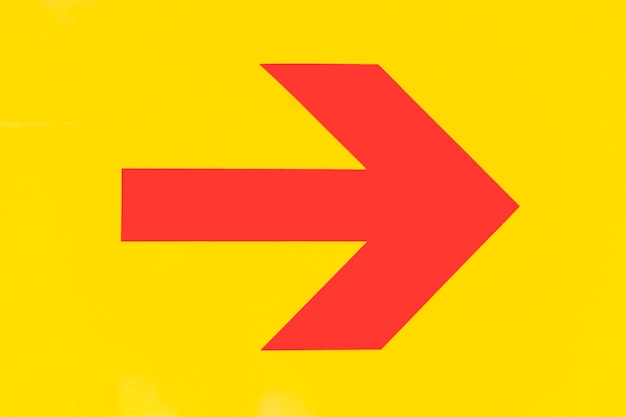 Pointy red arrow on yellow background