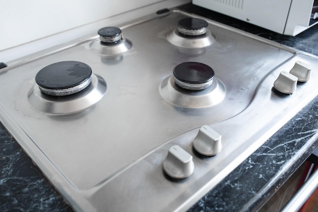 Free photo polished gas cooker after washingperfectly clean gas cooker after being washed with polishing chemicals the result of washing the burners