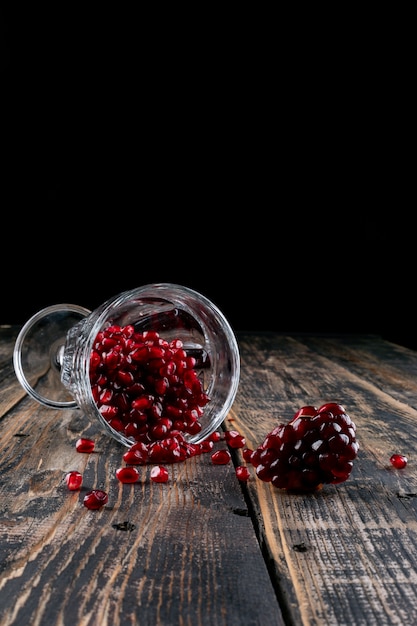 Free Photo pomegranate in glass on wooden table