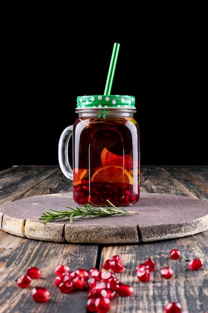 pomegranate juice in jar on wooden table