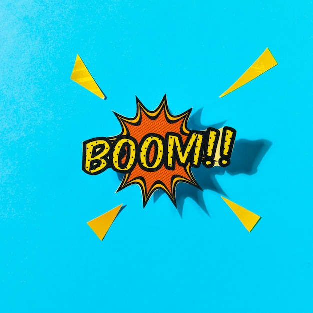 Pop art comics boom! speech bubble against blue backdrop