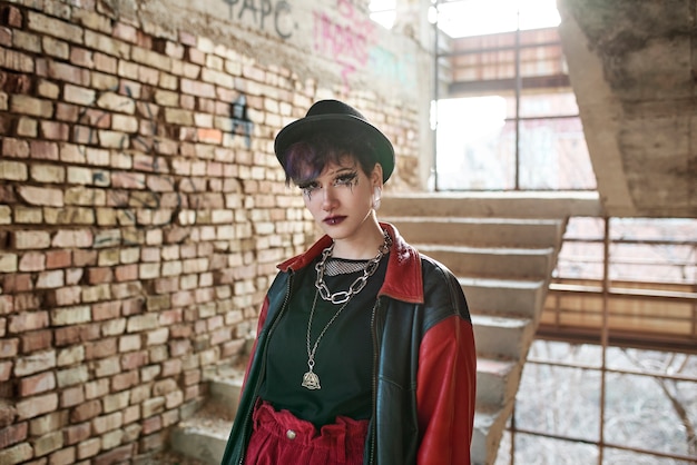 Free photo pop punk aesthetic portrait of woman posing inside building