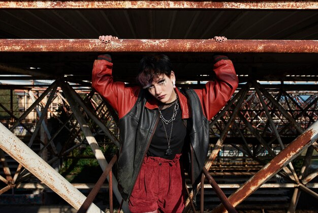 Pop punk aesthetic portrait of woman posing on metal structure