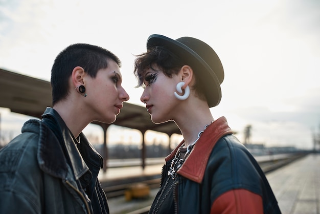 Pop punk aesthetic portrait of women posing in train station