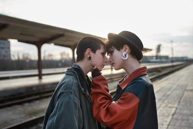 Pop punk aesthetic portrait of women posing in train station