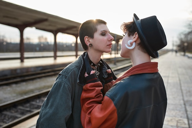 Free Photo pop punk aesthetic portrait of women posing in train station