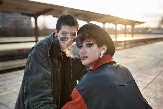 Pop punk aesthetic portrait of women posing in train station