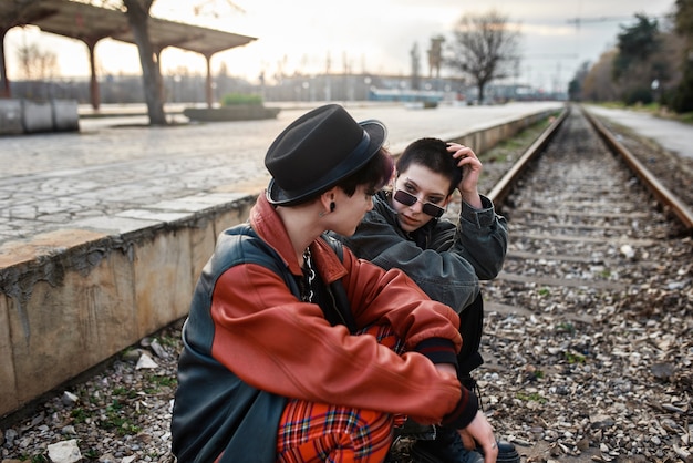 Free photo pop punk aesthetic portrait of women posing on train tracks