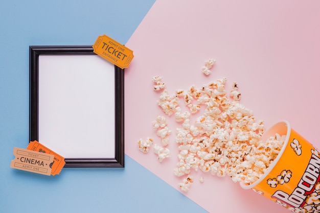 Free Photo popcorn box with cinema tickets and a frame