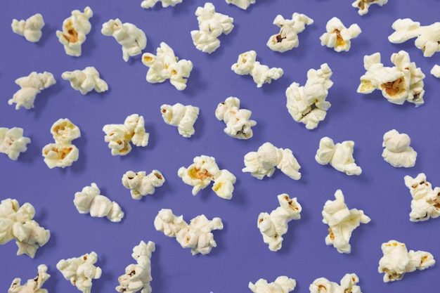 Free photo popcorn on dark purple color background top view