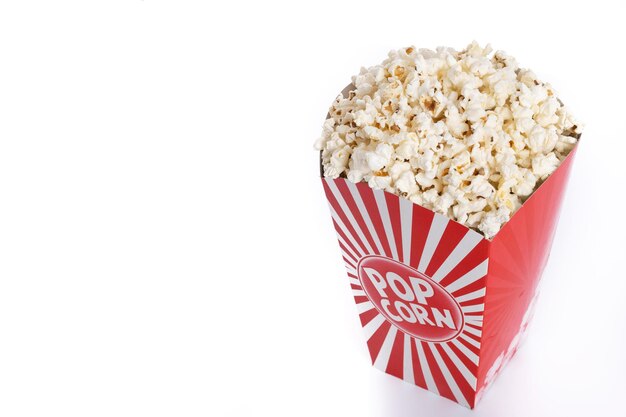 Popcorn in red and white striped cardboard bucket isolated on white background