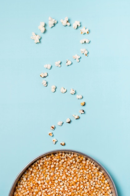 Popcorn waves near the popcorn seeds against blue backdrop