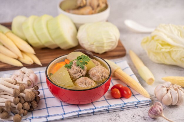 Pork ball soup in a cup on a blue-white cloth.