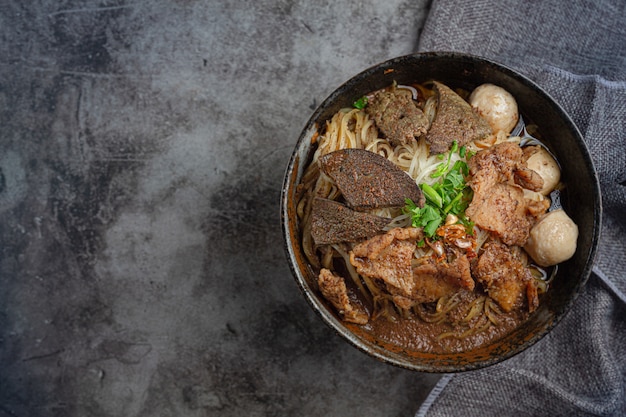 Pork boat noodles, classic Thai food and popular menus and ready to eat soups. There is also a basil in the bowl.