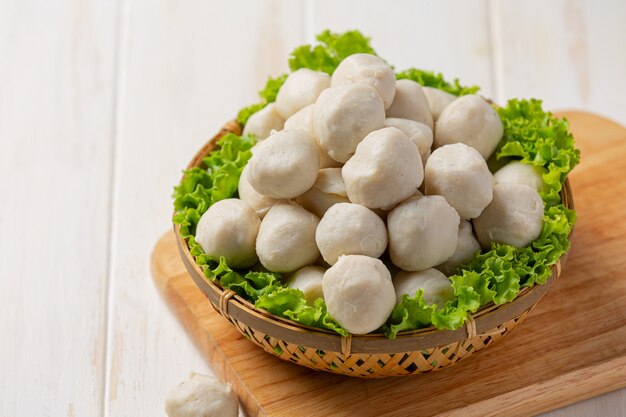 Pork meatballs on the white wooden surface.