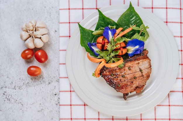 Pork Steak with Tomato, Carrot, Red Onion, Peppermint, Butterfly Pea Flower, and Lime.