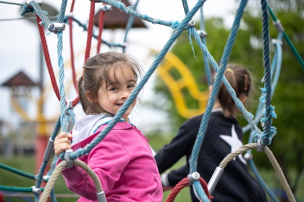 Porter of a little smiling girl playing in the playground.