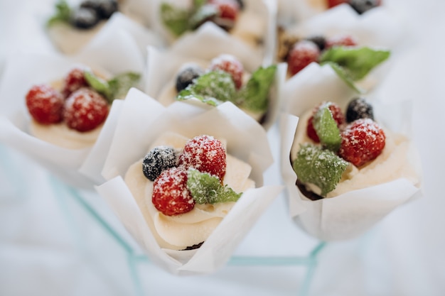 Free Photo portions desserts decorated with cream and berries