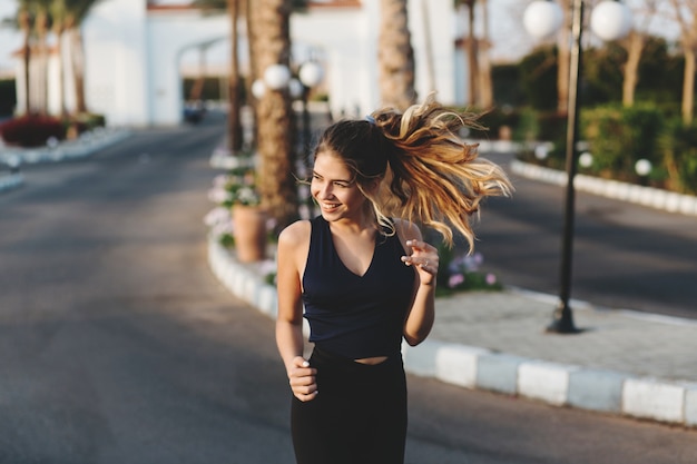 Portrait active joyful sportwoman running in park. Sunny morning, cheerful mood, motivation, workout, healthy lifestyle, fitness, attractive model