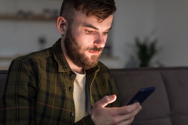 Portrait of adult male browsing mobile phone