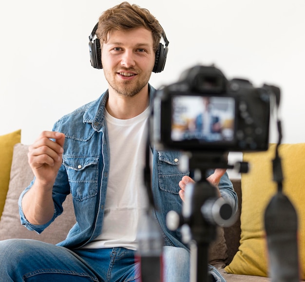 Portrait of adult male recording himself at home