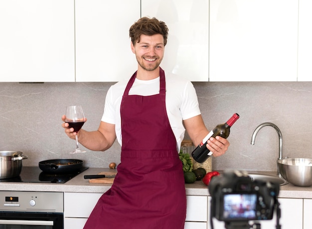 Free photo portrait of adult male recording whine tasting video