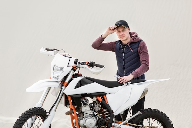 Portrait of adult male trying to repair motorcycle