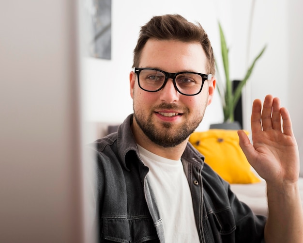 Portrait of adult male video conferencing from home