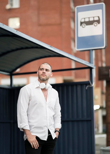 Free Photo portrait of adult male waiting for the bus