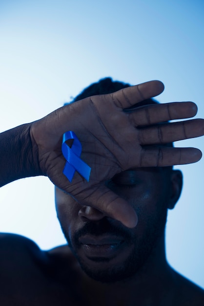 Portrait of african american man with blue ribbon