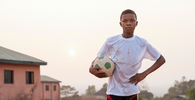 Portrait african child with football ball