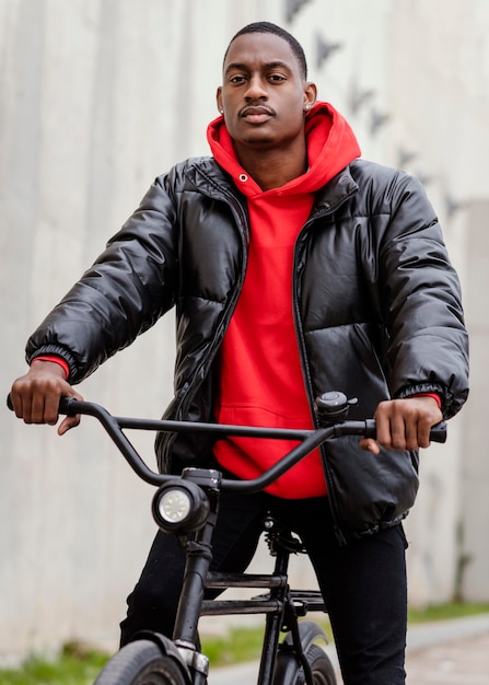 Portrait of afro-american man and his bicycle