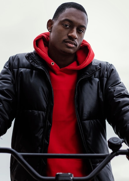 Portrait of afro-american man and his bicycle