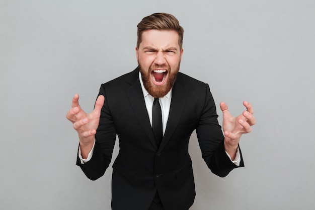 Free photo portrait of an angry bearded man in suit shouting