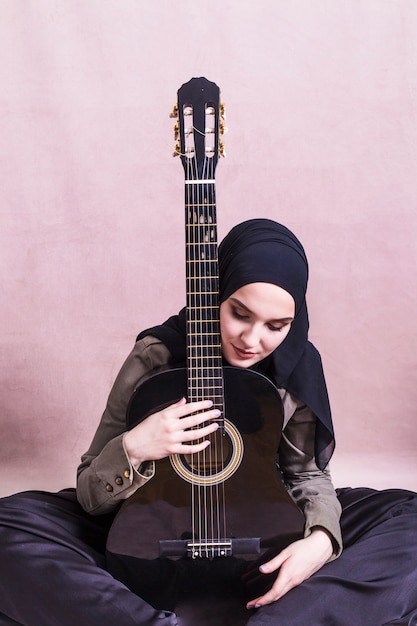 Portrait of arab woman with guitar