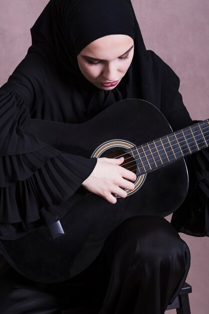 Portrait of arab woman with guitar