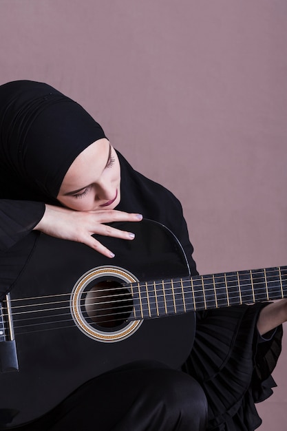 Free Photo portrait of arab woman with guitar