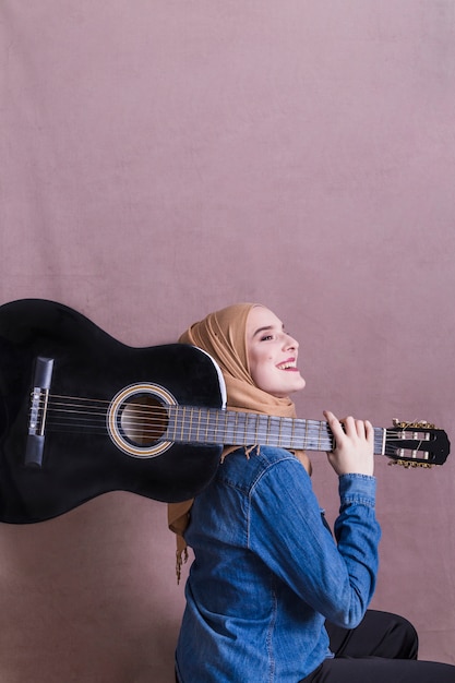 Free Photo portrait of arab woman with guitar