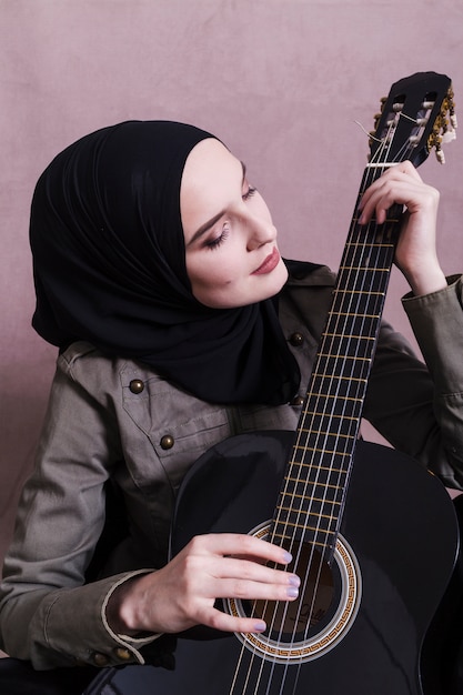 Portrait of arab woman with guitar