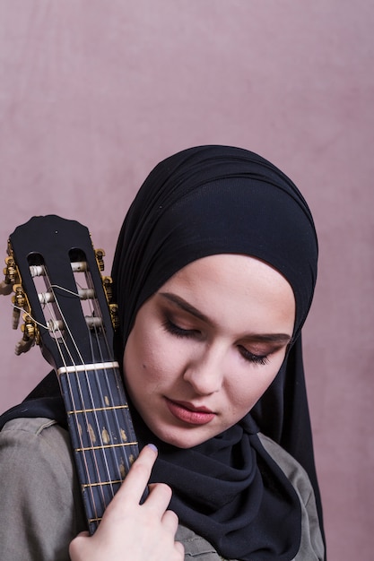 Free Photo portrait of arab woman with guitar