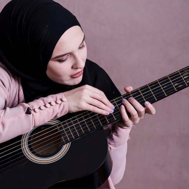 Free Photo portrait of arab woman with guitar